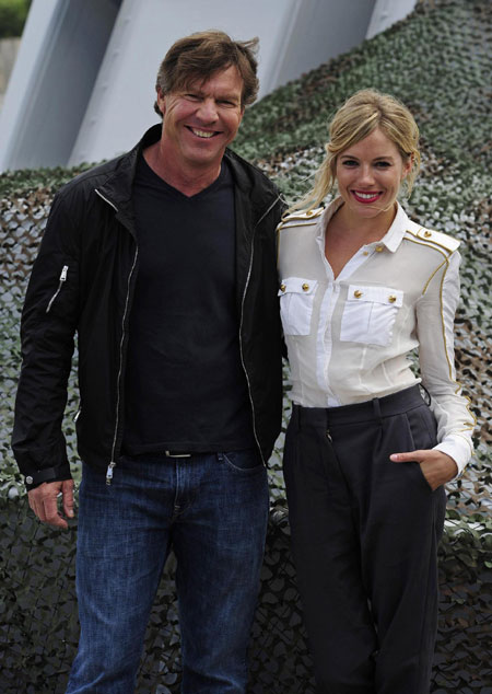 Sienna Miller poses for photographers during a photocall to promote