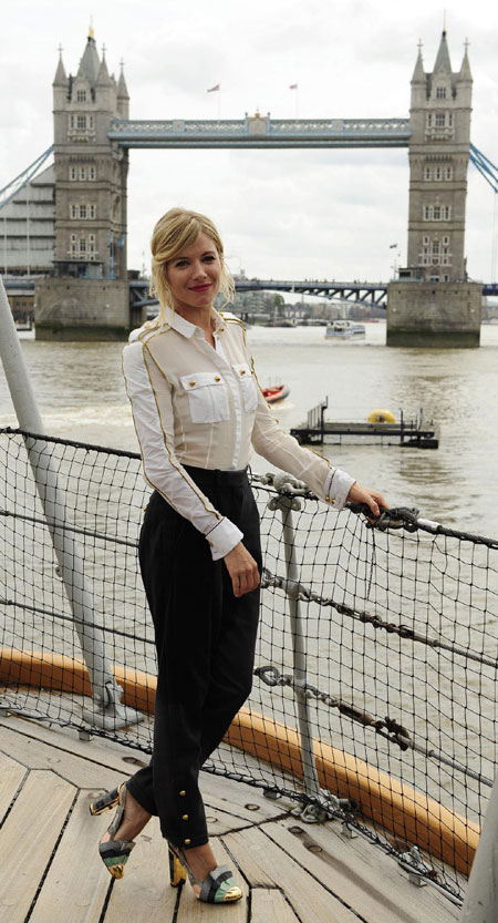 Sienna Miller poses for photographers during a photocall to promote 