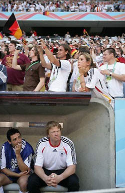 Germany's Oliver Kahn sits on the bench with team mate Oliver Neuville (L) as they wait for the start of their second round World Cup 2006 soccer match against Sweden in Munich June 24, 2006.