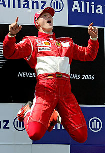 Ferrari's Formula One driver Michael Schumacher of Germany celebrates his victory on the podium at the French Grand Prix at the Magny-Cours circuit July 16, 2006.