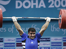 Harem Ali from Iraq lifts in the men's 77kg weightlifting class at the Asian Games in Doha December 4, 2006. Ali won the bronze medal.