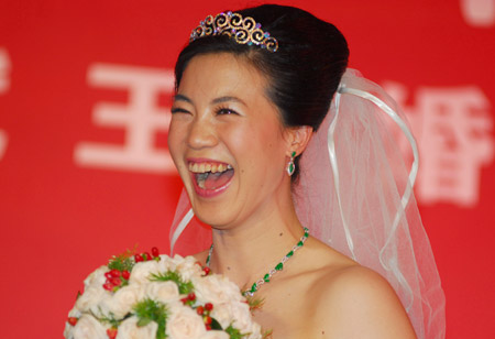 China's four-time Olympic table tennis gold medalist Wang Nan laughs at her wedding ceremony, September 27, 2008. Wang and her long-time partner Guo Bin tied the knot onboard a yacht in Yantai, Shandong Province on Saturday as Wang's teammate Ma Lin and Japan's most popular table tennis star Ai Fukuhara were best man and maid of honor respectively. [Xinhua]