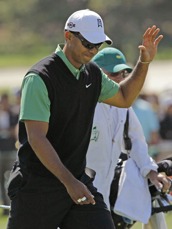 Woods tames course as charm offensive continues