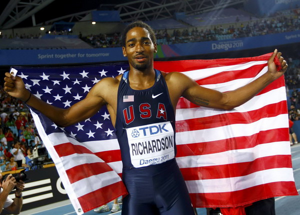 Jason Richardson of the US holds up his flag after taking second place at the men's 110 metres hurdles final at the IAAF 2011 World Championships in Daegu, August 29, 2011. Controversial gold is 'bittersweet' for Richardson