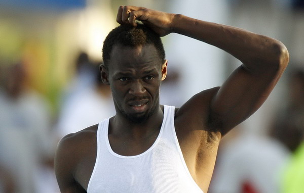 Usain Bolt of Jamaica scratches his head during a training session near the Athlete's village at the IAAF World Championships in Daegu August 31, 2011. IAAF will not rush to change rule that ousted Bolt