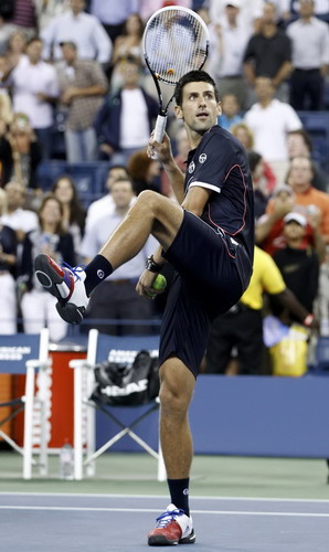 Novak Djokovic of Serbia hits tennis balls into the crowd after winning his evening match against Carlos Berlocq of Argentina at the US Open tennis tournament in New York Sept 1, 2011. Djokovic romps past Berlocq in US Open 2nd round