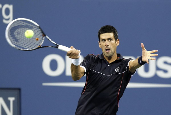 Novak Djokovic of Serbia returns a forehand to Carlos Berlocq of Argentina during their match at the US Open tennis tournament in New York Sept 1, 2011. Djokovic romps past Berlocq in US Open 2nd round