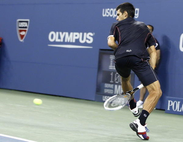 Novak Djokovic of Serbia returns the ball between his legs against Carlos Berlocq of Argentina during their match at the US Open tennis tournament in New York Sept 1, 2011. Djokovic romps past Berlocq in US Open 2nd round