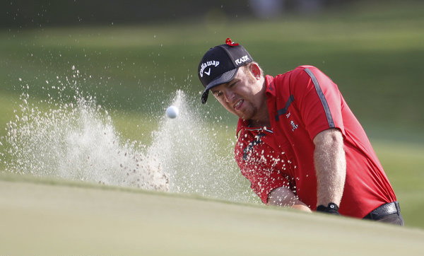 J.B. Holmes hits from the sand onto the 11th green during the second round of the Players Championship Golf Tournament in ponte vedra beach, Florida, May 13, 2011. Holmes has successful brain surgery