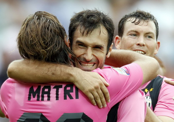 Juventus's Alessandro Matri (L) celebrates with his teammates Mirko Vucinic (C) and Stephan Lichtsteiner after scoring against Siena during their Italian Serie A soccer match at the Artemio Franchi stadium in Siena Sept 18, 2011. Lucky Juventus beat Siena 1-0