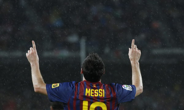 Barcelona's Lionel Messi celebrates a goal against Atletico Madrid during their Spanish First division soccer league match at Camp Nou stadium in Barcelona, Sept 24, 2011. European soccer sum-up