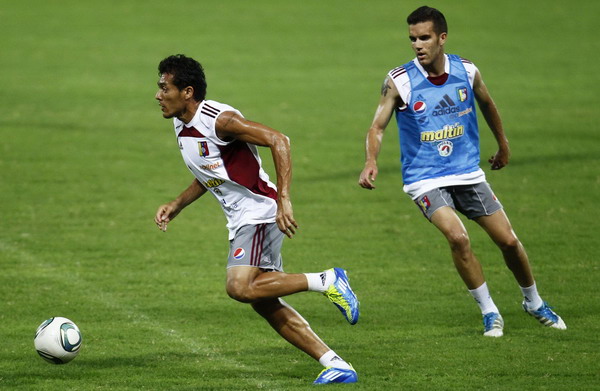 Venezuelan national soccer team player Juan Arango challenges a team mate during a training session in Puerto La Cruz Oct 9, 2011. S America geared up for world cup qualifying match