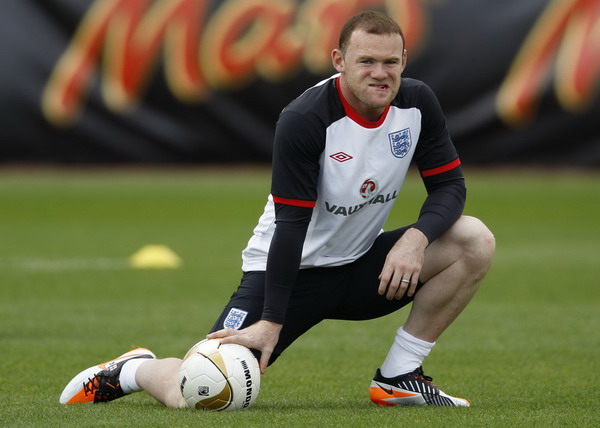 England's Wayne Rooney attends a team training session in London Colney, north of London in this Oct 4, 2011 file photo. England striker Rooney gets three-match ban