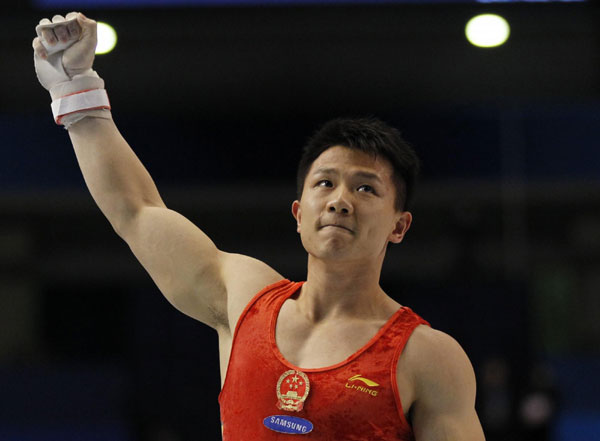 China's Chen Yibing reacts after competing on the rings during men's apparatus final at the Artistic Gymnastics World Championships in Tokyo October 15, 2011. Chen wins rings title at gymnastics worlds