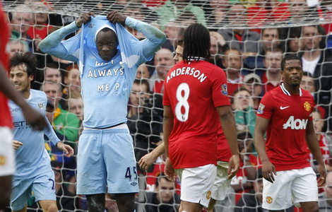 Manchester City's Mario Balotelli celebrates after scoring the opening goal against Manchester United during their English Premier League soccer match at Old Trafford in Manchester, northern England, Oct 23, 2011. Balotelli causes fireworks on and off pitch