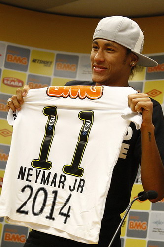 Santos soccer player Neymar holds up his team jersey after he signed a new contract with Santos in the city of Santos Nov 9, 2011. Neymar extends contract with Santos