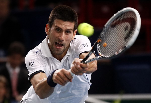 Serbia's Novak Djokovic returns the ball to Croatia's Ivan Dodig during the Paris Masters tennis tournament, Nov 9, 2011. Djokovic hits bonus jackpot in Paris