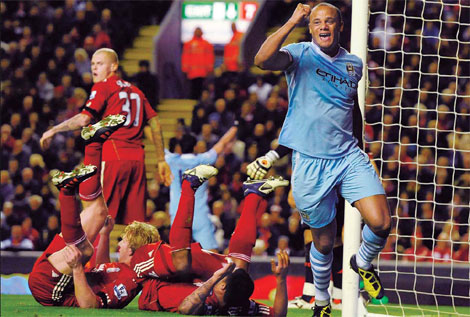 Manchester City manager Roberto Mancini accused Liverpool's players of getting Mario Balotelli sent off as the Premier League leaders were held to a 1-1 draw at Anfield. Mancini says Liverpool played cards a bit too well