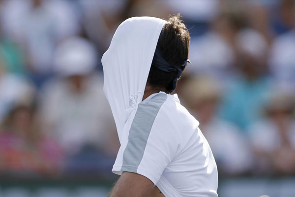 Juan Martin Del Potro of Argentina pulls his shirt over his face after losing a point against Rafael Nadal of Spain during their men's singles final match at the BNP Paribas Open ATP tennis tournament in Indian Wells, California, March 17, 2013. Comeback maestro Nadal wins third Indian Wells title