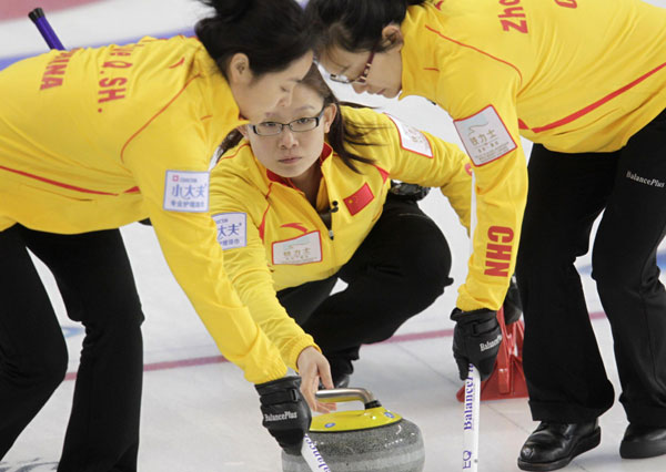 China's skip Wang Bingyu (C) delivers a stone during their World Women's Curling Championship qualification round match against Italy in Riga, March 18, 2013. China claims second victory in curling world cup