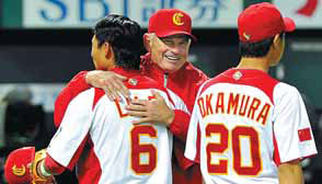 China's manager, John McLaren (center), congratulates infielder Li Lei (left) and Shu Okamura following their win over Brazil in the last inning of the first-round Pool A game in the World Baseball Classic in Fukuoka on March 5. Still swinging away