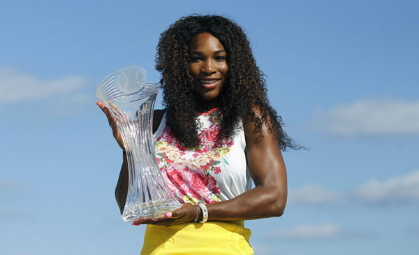 Serena Williams of the US poses on the beach with the championship trophy after she defeated Russia's Maria Sharapova in their women's singles final match at the Sony Open tennis tournament in Key Biscayne, Florida March 30, 2013. Serena beats Sharapova in Sony Open final
