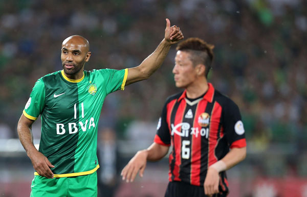 Kanoute, left, of Beijing Guoan reacts during their first leg game of AFC Champions league last 16 against FC Seoul of South Korea at the Workers' Stadium in Beijing, May 14, 2013. Beijing Guoan draws 10-man FC Seoul in champions league home leg
