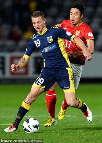 Central Coast Mariners player Mitchell Duke (L) controls the ball ahead of China's Guangzhou Evergrande player Zhoa Xuri (R) in an AFC Champions League round of 16 first leg match in Gosford, Australia, May 15, 2013. Evergrande on top after tough fight with Mariners