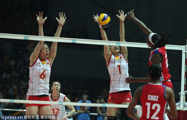 Chinese players jumps to block Cuban players' offense during their Beilun International Volleyball Tournament in Ningbo city, Zhejiang province, May 19, 2013. China wins first title under Lang Ping's rein