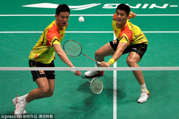Cai Yun, left, and Fu Haifeng of China compete against Hendra Setiawan and Angga Pratama of Indonesia during their men's doubles badminton match at the Sudirman Cup world team badminton championships in Kuala Lumpur, Malaysia, May 21, 2013. China sweeps Indonesia to reach quarters at Sudirman Cup