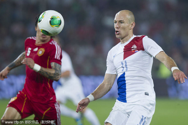 Arjen Robben (11) of the Netherlands is challenged by China's Zhang Linpeng (5) during their international friendly soccer match at the Workers' Stadium in Beijing, June 11, 2013. China lost to star-studded Holland in intl friendly