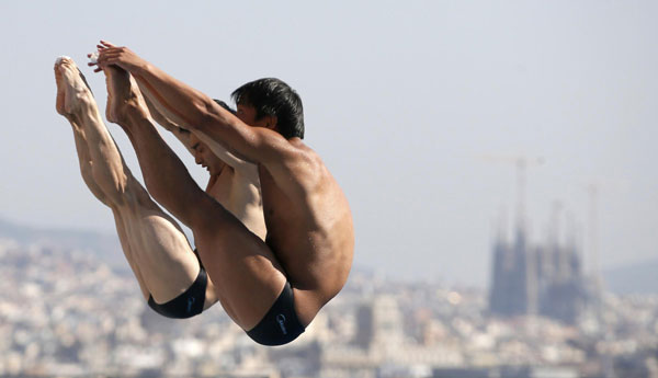 China's Qin Kai and He Chong perform a dive at the men's synchronised 3m springboard preliminary during the World Swimming Championships at the Montjuic municipal pool in Barcelona, July 23, 2013. Chinese pair wins gold in men's 3m synchro springboard