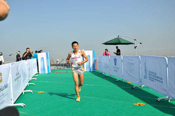 A runner runs to the finish line during the vertical marathon at the inaugural China World Summit Wing Hotel Vertical Run in Beijing, on Aug 3, 2013. International vertical run debuts in Beijing