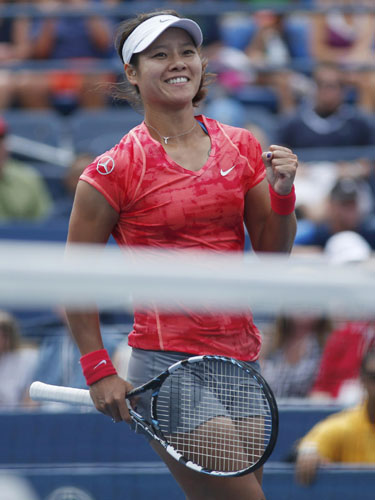 Li Na of China reacts after defeating Olga Govortsova of Belarus at the US Open tennis championships in New York, Aug 26, 2013. China's role model, Li, rolls on