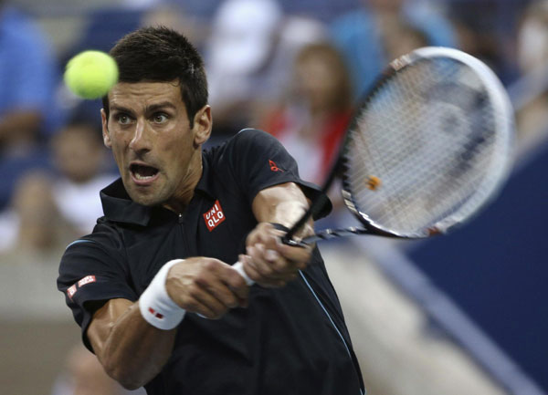 Novak Djokovic of Serbia returns a backhand to Joao Sousa of Portugal at the US Open tennis championships in New York, Sept 1, 2013. Serena beats Stephens as Murray cruises
