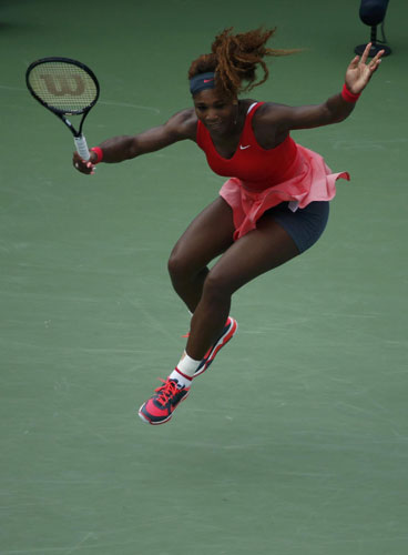 Serena Williams of the U.S. leaps as she returns to compatriot Sloane Stephens at the U.S. Open tennis championships in New York September 1, 2013. Serena beats Stephens as Murray cruises