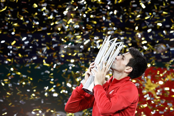 Novak Djokovic of Serbia kisses the trophy after winning the men's singles final match against Juan Martin Del Potro of Argentina at the Shanghai Masters tennis tournament October 13, 2013. Djokovic retains Shanghai Masters title