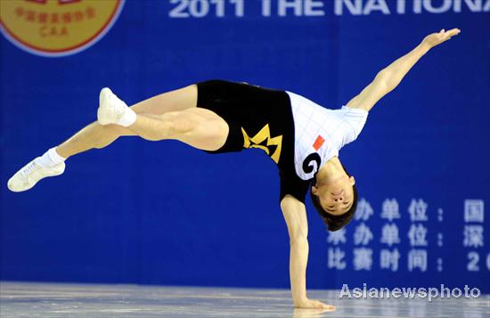 A contestant competes in the national aerobics tournament held in the gymnasium of Futian District Sports Park, June 17, 2011, as a test event ahead of the Universiade, which is held from Aug 12 in Shenzhen. A testing aerobic workout for Universiade