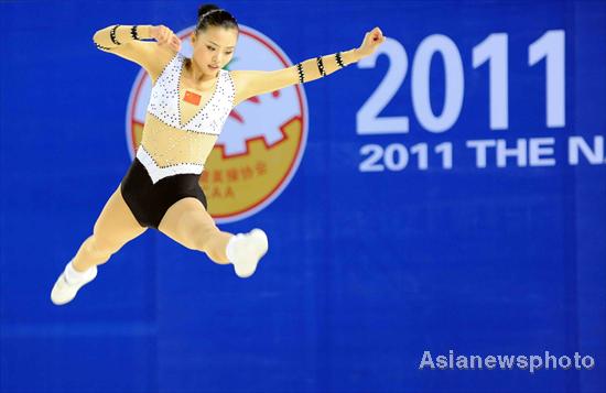 A contestant competes in the national aerobics tournament held in the gymnasium of Futian District Sports Park, June 17, 2011, as a test event ahead of the Universiade, which is held from Aug 12 in Shenzhen. A testing aerobic workout for Universiade