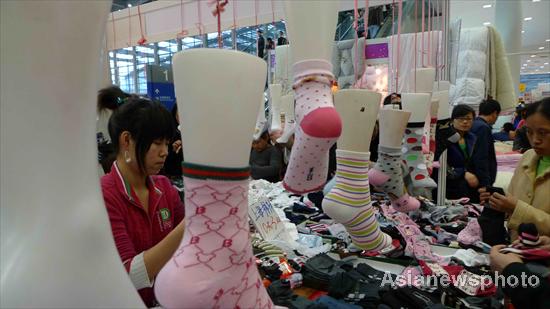 People choose socks at the Shenzhen Shopping Carnival held in Shenzhen, South China's Guangdong province, January 2, 2011. Many companies and tradesmen offer discounted goods at the annual trade fair. Discounted goods at Shenzhen Shopping Carnival