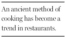 Chefs return wood to the cooking fire