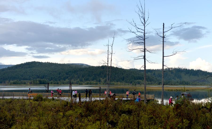 Mist-shrouded mountains seen near lakes in Arxan, N China