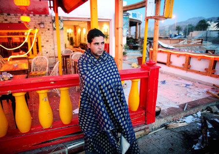 An Egyptian man stands in front of a damaged restaurant in the Red Sea resort of Dahab April 25, 2006 . Bombers have struck again at a resort in Egypt's Sinai peninsula, killing at least 23 people in three nearly simultaneous explosions in a market and restaurant area popular with foreign tourists.