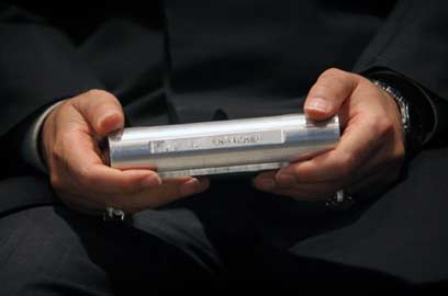 Iran's Astan Qods Razavi museum chief carries a sample of enriched uranium after Iranian President Mahmoud Ahmadinejad speeches in Mashad, 924 km (574 miles) east of Tehran, April 11, 2006.