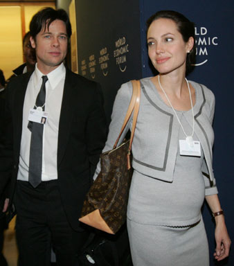 U.S. actress Angelina Jolie (R) and U.S. actor Brad Pitt leave a session at the World Economic Forum in Davos, Switzerland in this January 26, 2006 file photo.