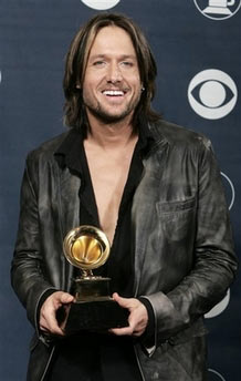 Keith Urban holds his Grammy award for Best Male Country Vocal Performance in this Wednesday, Feb. 8, 2006 file photo, in Los Angeles. Urban is country music's sexiest man, according to a reader poll to be released Friday, June 16, 2006 in Country Weekly. (AP Photo/Reed Saxon)