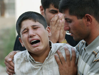 A boy cries after his father was among soldiers killed at an army checkpoint in Kirkuk, about 250 km (150 miles) north of Baghdad, July 14, 2006. Gunmen ambushed an Iraqi army checkpoint in northern Iraq on Friday, killing 12 soldiers and wounding one, in one of the deadliest single attacks in months against the U.S.-trained Iraqi forces.