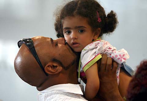 Evacuees from Lebanon are welcomed after their arrival on a special flight from Damascus at Cologne airport July 20, 2006. Three Airbus A-310 planes of the German Air Force Luftwaffe brought 500 evacuees on Thursday from Adana, Turkey, and Damascus, Syria, to Germany.
