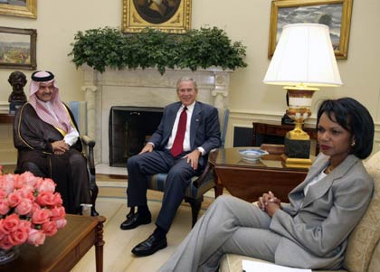 U.S. President George W. Bush (C) smiles with Saudi Foreign Minister Prince Saud al-Faisal as U.S. Secretary of State Condoleezza Rice (R) looks on before their meeting in the Oval Office of the White House in Washington July 23, 2006.