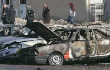 Burnt vehicles lie at the scene of a car bomb attack in a parking lot of Mahmoun University in Baghdad December 11, 2006. The attack killed one person and wounded four others, including two policemen.